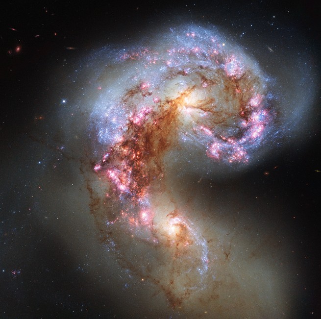 A pair of glittering galaxies caught in the process of merging together