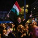 Attendees at a Tisza-party election event cheer as Hungarian Prime Minister Viktor Orbán concedes during parliamentary elections in Budapest