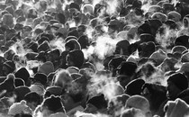 Black and white photo of a crowd of people in winter weather, their breath visible