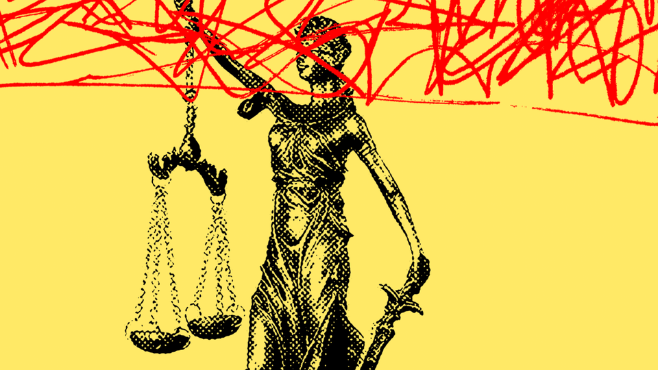 Lady Justice scrawled over with red