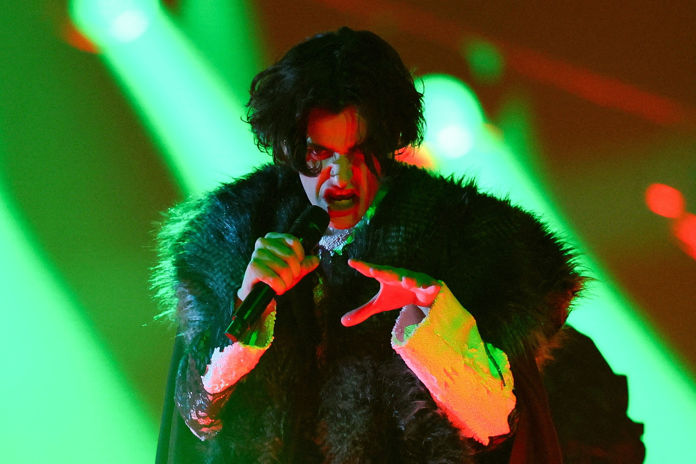 The singer gives out sinister faces as he looks at the camera during the performance.