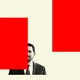 John Seago surrounded by red graphical blocks