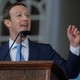 Mark Zuckerberg stands at a podium. 