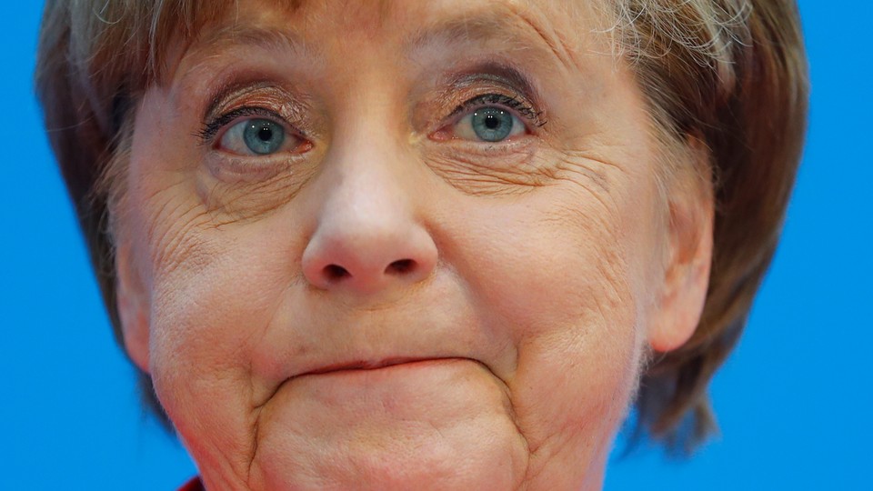 A close-up of Angela Merkel frowning