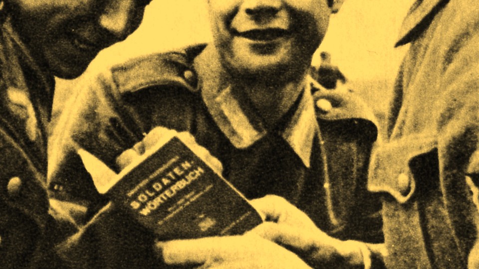 A yellow tinted cropped grainy photograph of soldiers looking into a German dictionary
