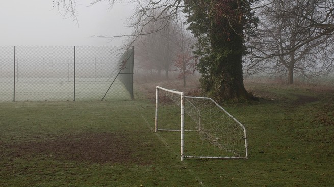 photograph of a misty soccer field