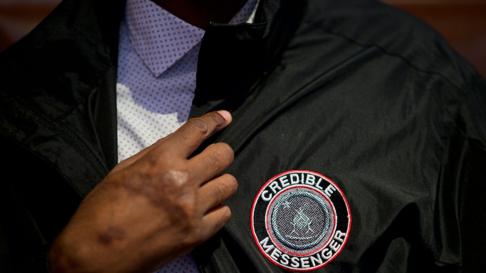 Norman Brown, a credible messenger who spent 22 years in federal prison and is now employed by the Department of Youth Rehabilitation Services, shows off his jacket.