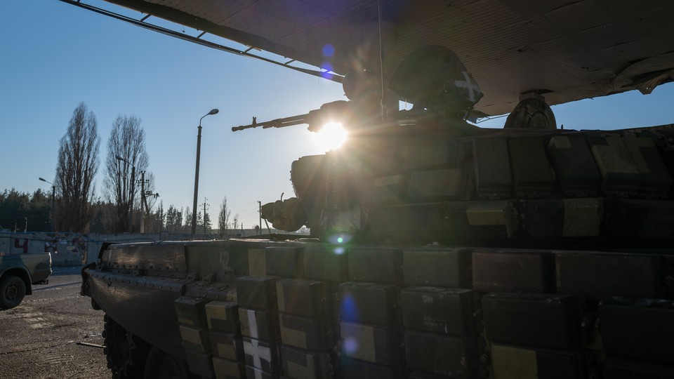 A Ukrainian tank sits under covering in the Kharkiv district of Ukraine