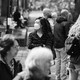 Black-and-white photo of masked woman on a crowded street