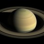 A picture of Saturn and its rings hovering in the darkness of space
