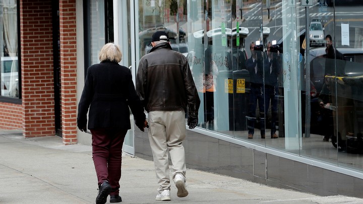 An elderly couple walking in New York