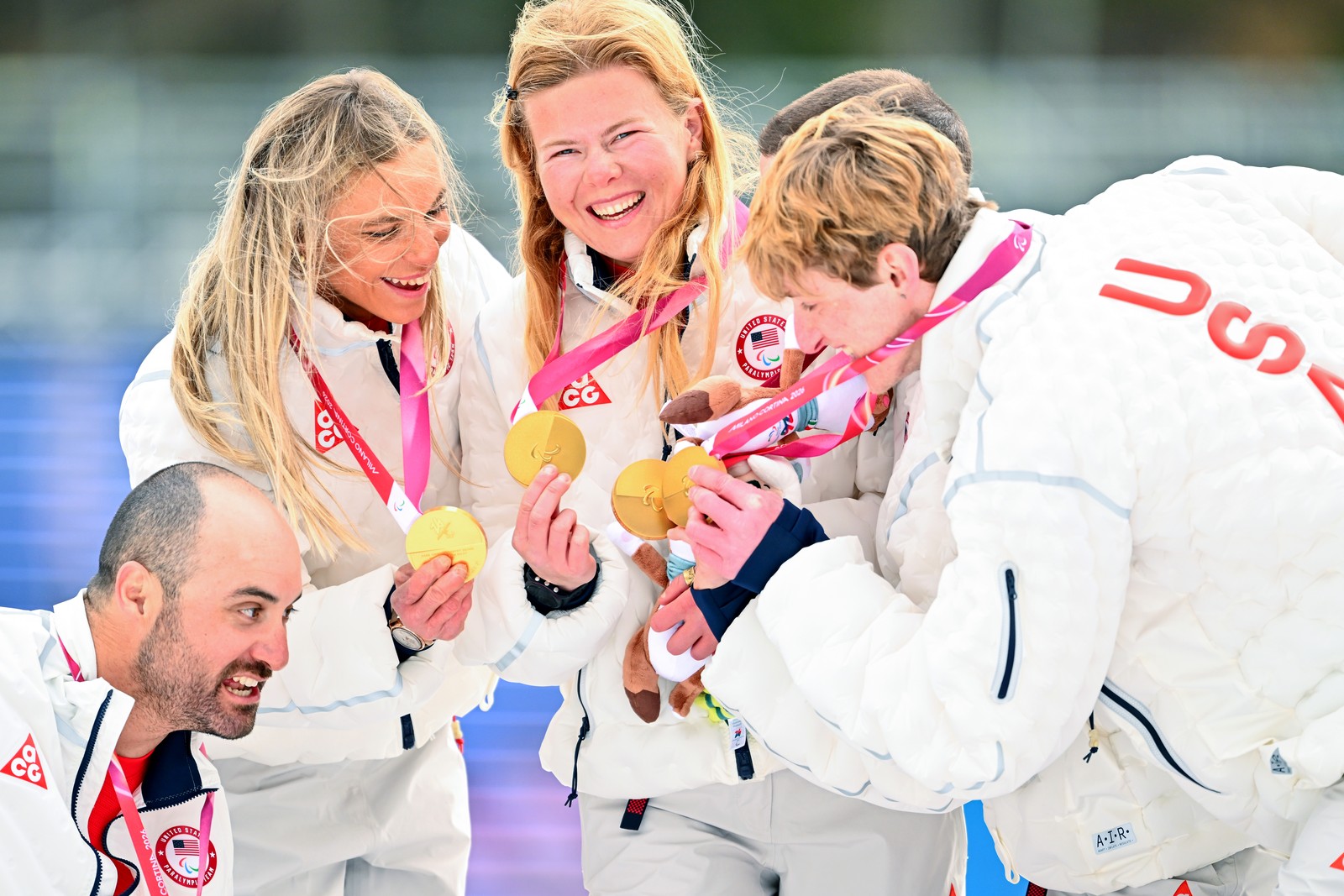 Members of Team USA celebrate with their gold medals on the podium.
