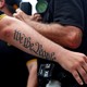 A person's arm has a tattoo that says "We The People"