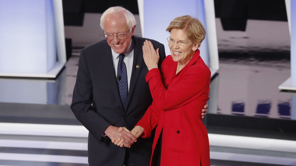 Senators Bernie Sanders and Elizabeth Warren greet each other on the debate stage in Houston, Texas.