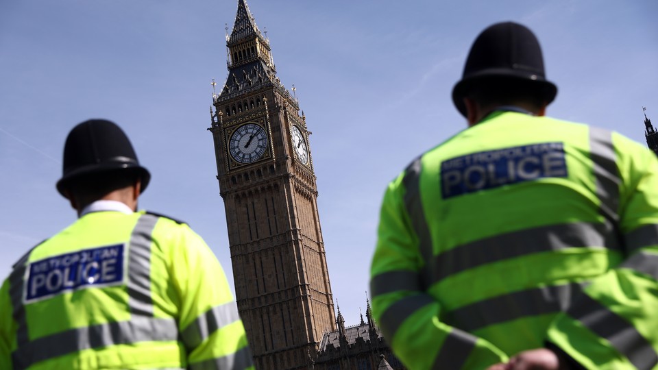 Police officers patrol in Parliament Square following an attack in central London on March 26, 2017.