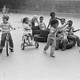 A black and white image of a group of children on a playground