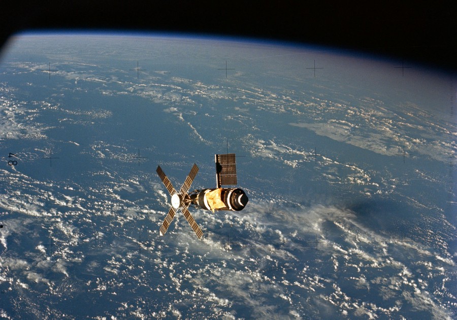 A view of a small space station orbiting above the Earth.