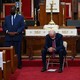 Joe Biden sits in a church with his head bowed.