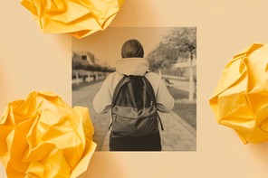 A student walks outside wearing a backpack