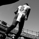 Black-and-white photo of football quarterback No. 8 poised to start running in crowded stadium