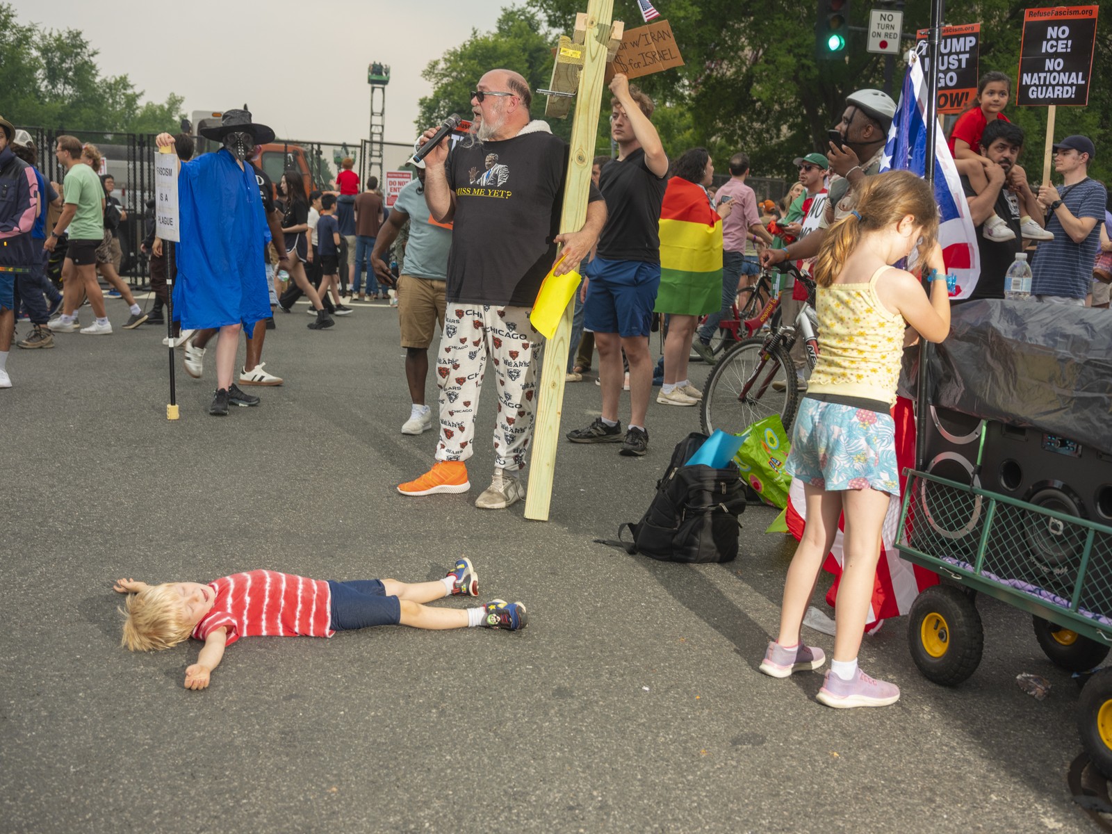 Picture of a child taking a moment of respite as protesters demonstrate near the parade route. 