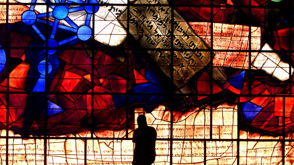 A student is silhouetted against the Ardon Windows, which contain imagery derived from the Zohar, in the library of the Hebrew University of Jerusalem.