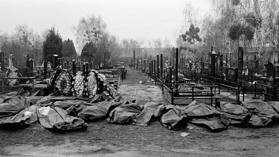 Body bags lie in a cemetery in Bucha, Ukraine.