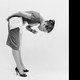 Two black-and-white pictures of women trying cures for hiccups: drinking water in a weird position, covering ears while holding breath.