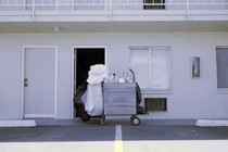 A motel cleaning cart in front of an open door
