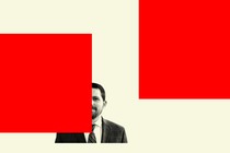 John Seago surrounded by red graphical blocks