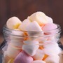 Mini multicolored marshmallows in a glass jar