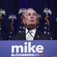 Michael Bloomberg stands at a lecturn.