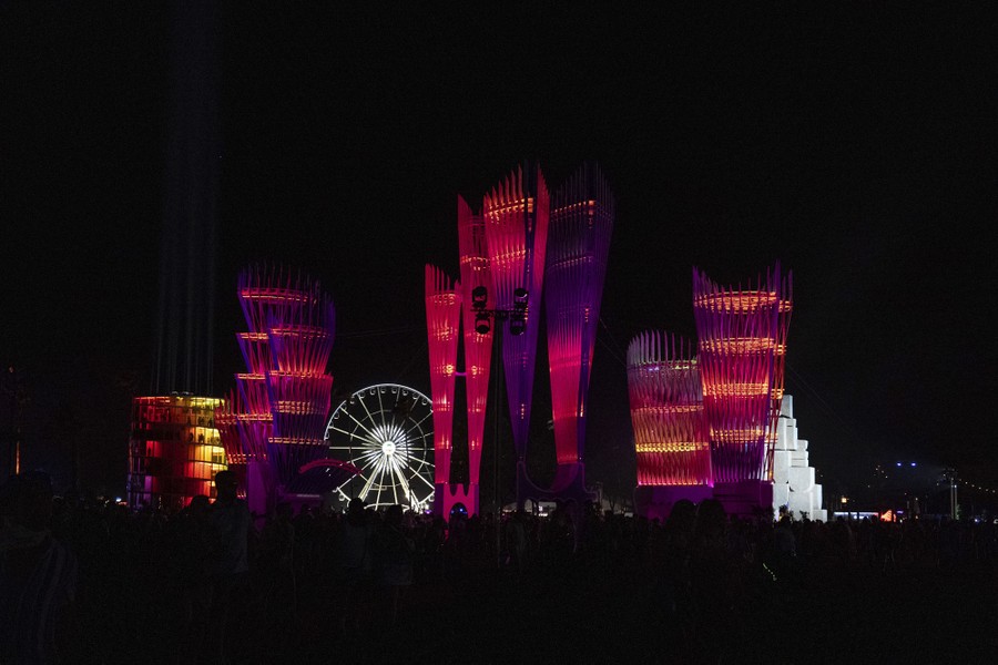 A night view of illuminated structures and a Ferris wheel