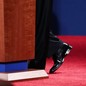 A presidential candidate’s feet at the base of a podium in a presidential debate
