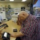 A man picks up prescriptions at a pharmacy.