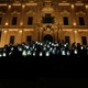 People standing outside a building hold up photos of Daphne Caruana Galizia during a protest.