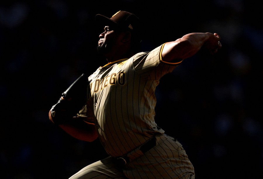 A baseball pitcher throws a pitch.