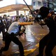 A police officer strikes a Hong Kong protester with a baton.