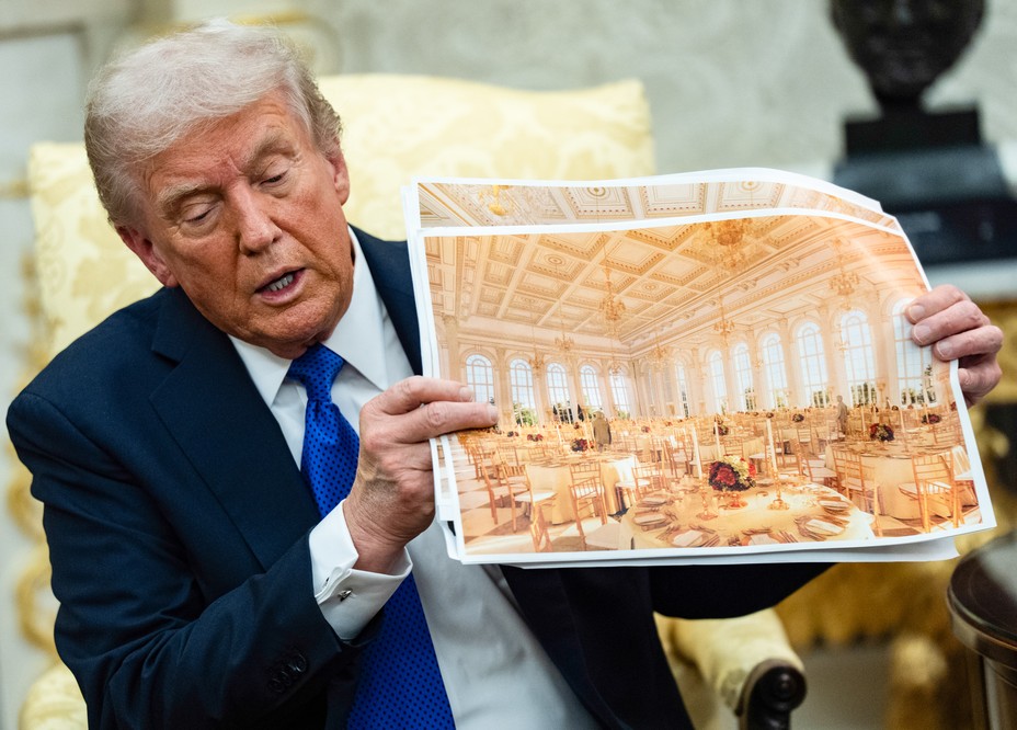 Donald Trump holds up a paper