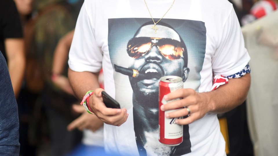 An attendee of the Made in America festival wears a Kanye West shirt