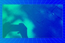 Photograph of a shadow of hands holding a smartphone