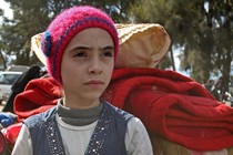 Syrian girl Noor, famous for broadcasting clips on social media about the regime-bombardments on the former rebel-held town of Jobar in Eastern Ghouta, arrives in Qalaat al-Madiq after being evacuated from Arbin on March 30, 2018.