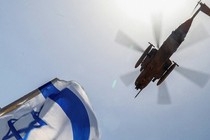 Israeli flag and helicopter flying over blue sky