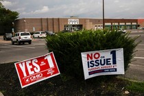 A photo showing "vote yes" and "vote no" signs outside an early-voting site in Ohio