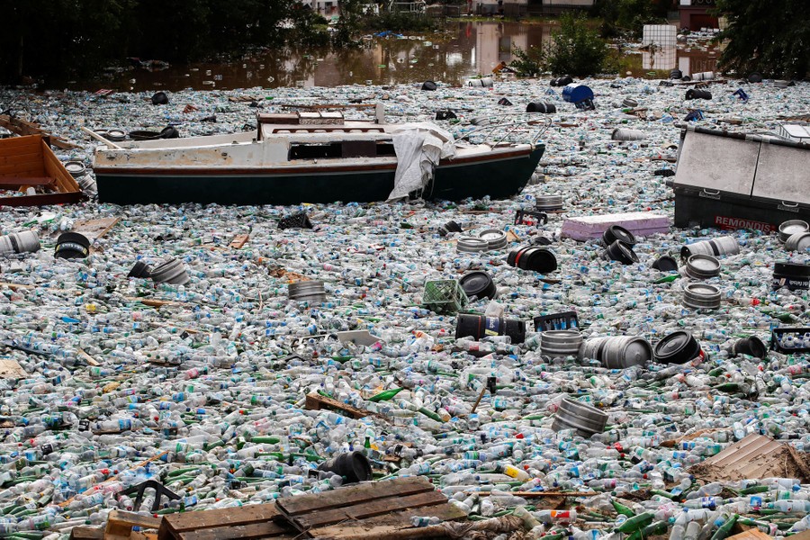 A large patch of garbage sits among flood debris.