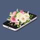 A smartphone under a bouquet of flowers