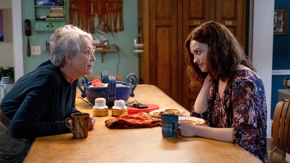 Jamie Lee Curtis and Emma Mackey sitting across each other at a table in “Ella McCay”