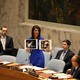 U.S. Ambassador to the United Nations Nikki Haley holds photographs of victims during a meeting at the United Nations Security Council on Syria at the United Nations headquarters on April 5, 2017.