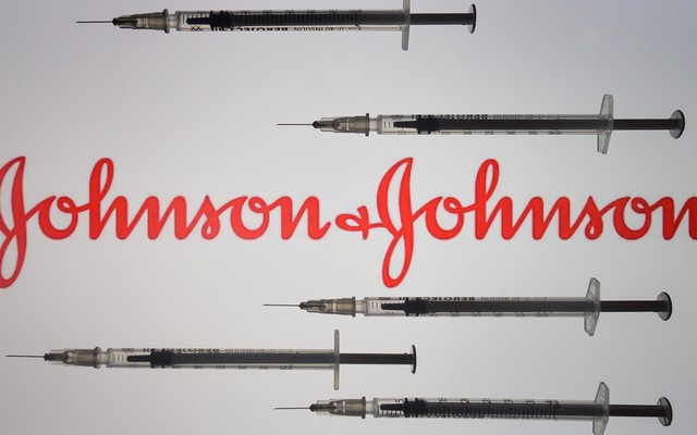 Vaccine needles surrounding the Johnson & Johnson logo