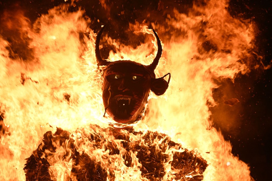A devil figure is set ablaze during a festival.